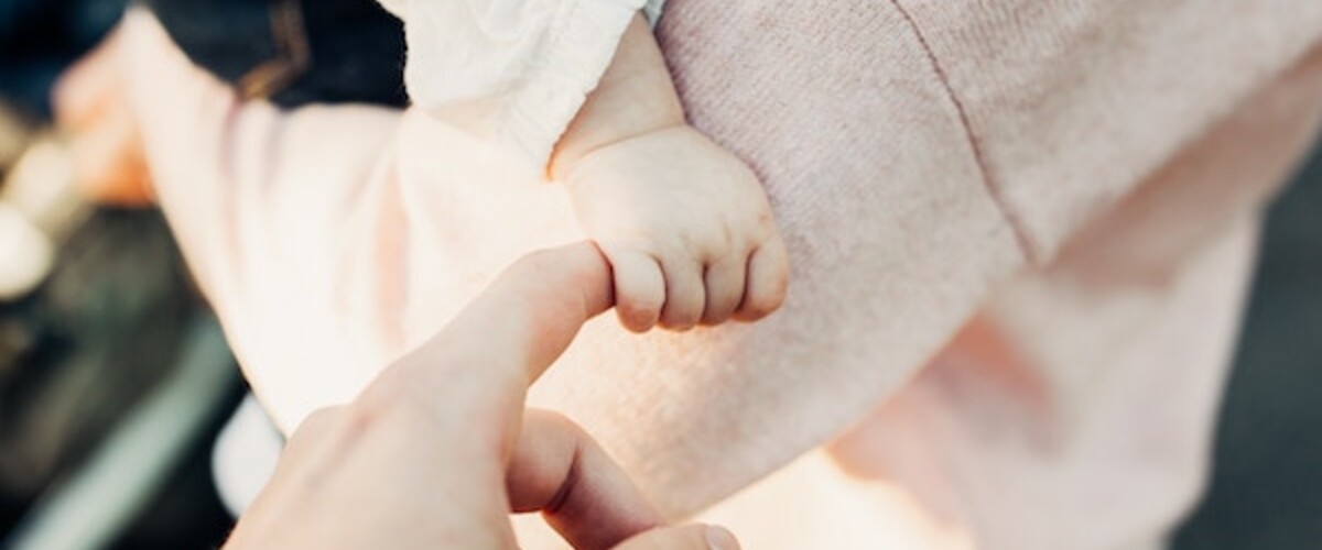 holding baby hand