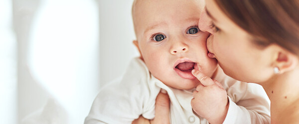 mother kissing baby