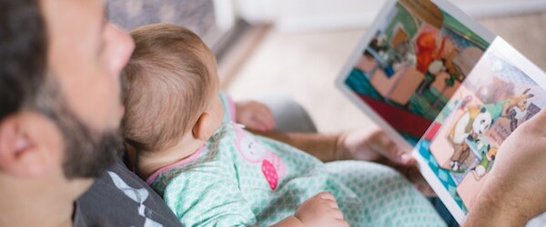 father and baby reading book